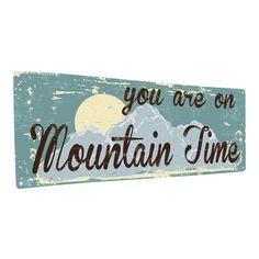 a wooden sign that says you are on mountain time with the moon in the background