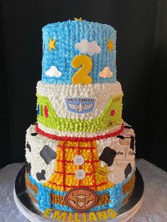 a three tiered cake with cars and stars on it