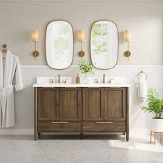 a bathroom with two sinks and three mirrors on the wall next to a bath tub