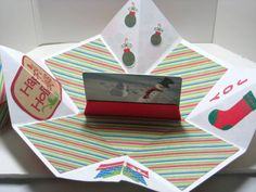 an origami christmas card is displayed on a table