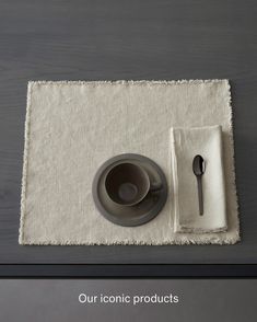 a place mat with a bowl, spoon and napkin on it