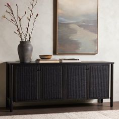 a vase sitting on top of a black cabinet