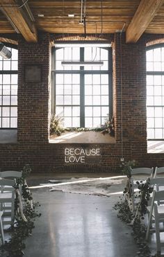 an empty room with rows of chairs and windows that say because love is in the air