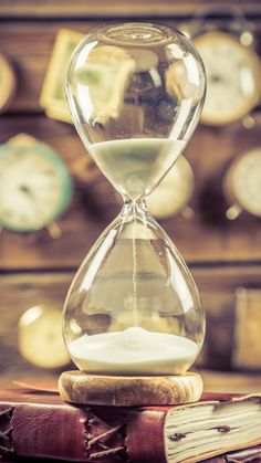 an hourglass sitting on top of two books