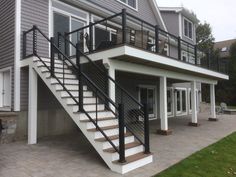 a black and white stair case in front of a house