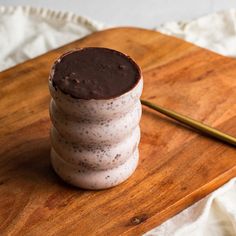 a stack of cookies sitting on top of a wooden cutting board