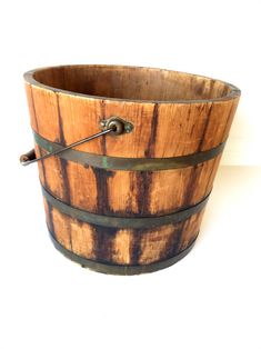 a wooden bucket with metal handles on a white background