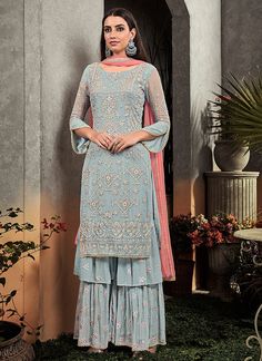 Blue And Peach Floral Embroidered Palazzo Suit will make you look elegant and stylish on any indian wedding function. This set has all the ethnic hues of zari, resham thread and stone embroidery work on its georgette top paired with georgette embellished palazzo bottom with santoon inner for top and bottom. Simple and elegant satin bordered chiffon dupatta. Wear this with a pair of heels and golden jewellery to have a desi girl look. *The set contains a straight cut top, palazzo bottom and a dup Garara Designs, Palazzo Dress, Bollywood Suits, डिजाइनर कपड़े, Palazzo Suit, Sharara Suit, Utsav Fashion, Designer Salwar Suits, Salwar Kameez Designs