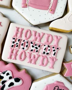 decorated cookies with the words how do you know? and cow designs on them, all in pink