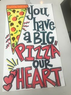 a piece of paper that says, you have a big pizza our heart on it