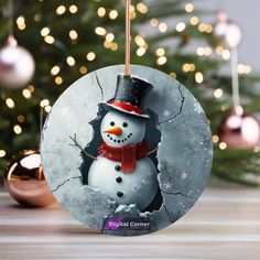 a snowman ornament hanging from a christmas tree