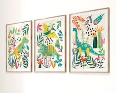 three framed art pieces hang on the wall next to each other, depicting dinosaurs and plants