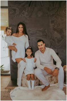 a family posing for a photo in their living room