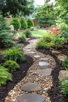 A winding stone path through a lush garden with various plants and flowers. Zero Scaping Ideas, Acreage Landscaping Ideas, Woods Backyard Ideas, Homestead Landscaping, Wooded Backyard Landscape, Cozy Patios, Dry Riverbed Landscaping, Backyard Landscape Ideas, Colorado Landscaping