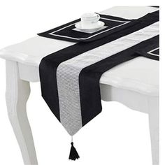 a black and white table runner with tassels