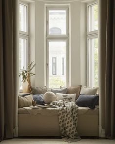 a living room filled with furniture and windows