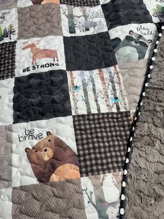 there is a quilt that has animals on it and the words be strong printed on it