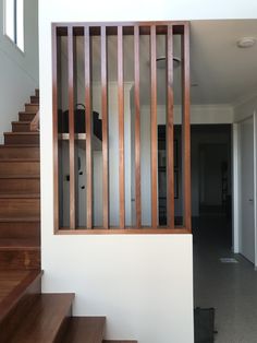 the stairs are made of wood and have vertical slats on each handrails