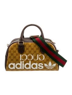 Gucci x Adidas Top Handle BagFrom the Fall/Winter 2022 Collection by Alessandro MicheleYellowGG CrystalAntiqued Gold-Tone HardwareLeather TrimRolled Handles & Single Adjustable Shoulder StrapLeather Trim EmbellishmentCanvas Lining & Single Interior PocketZip Closure at TopProtective Feet at Base Gucci Overnight Bag, Gucci X Adidas, Mini Duffle Bag, Adidas Top, Handbag Handles, Winter 2022, Adidas Tops, The Fall, Top Handle