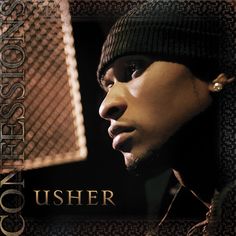 a man with a beanie on his head in front of a microphone and an advertisement for usher