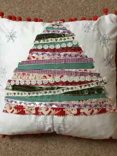 a christmas tree pillow on the floor