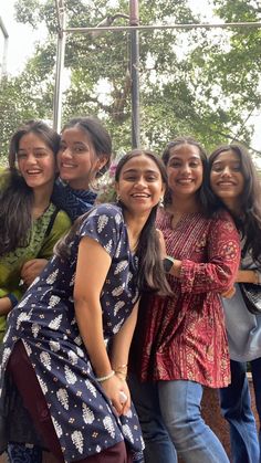 group of young women standing next to each other