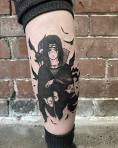 a person with a black and white tattoo on their leg