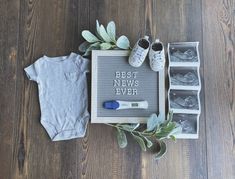 a baby's outfit, booties and t - shirt are laid out on the floor