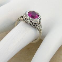 Vintage Estate 2.00 Carat Lab Created Ruby Solitaire Filigree Ring. Floral Designs. 925 Solid Sterling Silver. The Top Of The Ring Measures 3/8 Inches In Length. Set With One 6.5 mm High Quality Lab Created Ruby Stone. Stamped 925. Excellent Condition/Like New. Elegant Red Ruby Ring In Sterling Silver, Heirloom Style Lab-created Ruby Ring As A Gift, Pink Rings With Intricate Design For Anniversary, Heirloom Style Lab-created Ruby Ring Gift, Antique Diamond Cut Ruby Ring For Anniversary, Antique Ruby Ring With Diamond Cut For Anniversary, Antique Ruby Ring With Filigree For Anniversary, Elegant Sterling Silver Ruby Ring Gift, Elegant Red Sterling Silver Ring