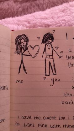 an open notebook with drawings of two people holding hands and the words i love you written on it