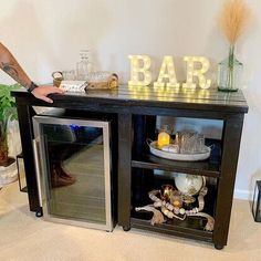 a man standing in front of a bar with the word bar written on it's side