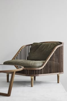 a chair and table sitting on top of a white floor