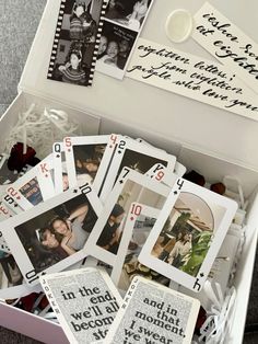 a box filled with lots of cards and pictures on top of each other in it