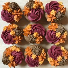 twelve cupcakes decorated with orange and brown flowers