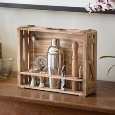 a wooden box filled with metal items on top of a table