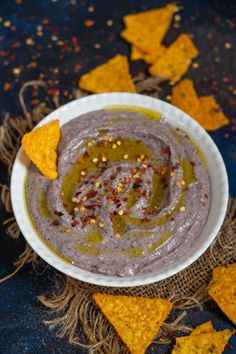 the best black bean hummus is served in a bowl with tortilla chips