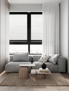 a living room with a couch, coffee table and large window