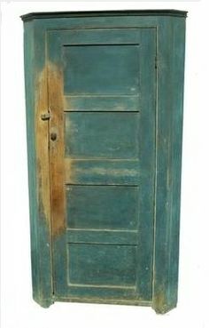 an old green cabinet with a door and handle on the front, against a white background