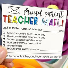 a person holding up a teacher mail card