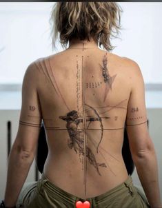 the back of a woman's body with tattoos on her upper and lower back