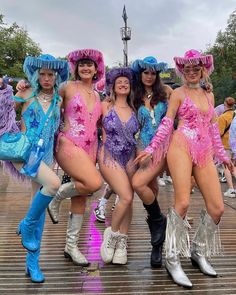 four women in costumes posing for the camera