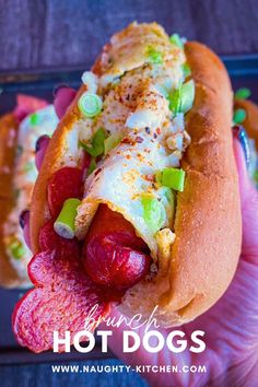 the hot dog is loaded with toppings and ready to be eaten