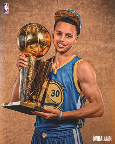 the basketball player is holding up his trophy