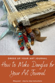 an art journal with the title dress up your art journal how to make dangles for your art journal