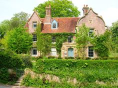 an old brick house with ivy growing on it's sides