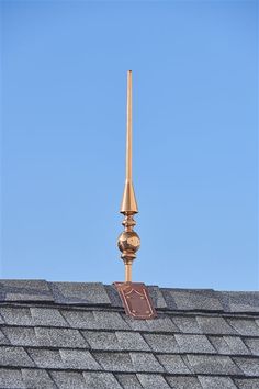 a weather vane on the roof of a house