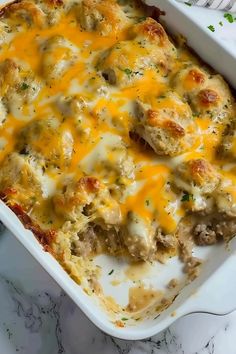 a casserole dish with meat and cheese in it on a marble counter top