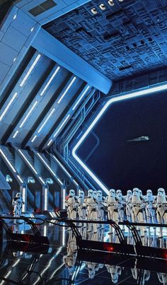 a scene from star wars the force awake with stormtroopers lined up on stage