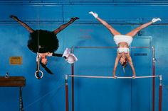 two women are performing aerial acrobatic tricks