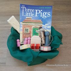 there is a book about little pigs and other things in the basket on the floor